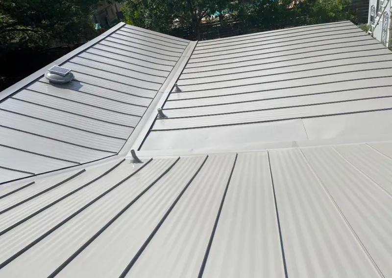 Solar attic fan installed on a metal roof for Roof Ventilation in Shoreline